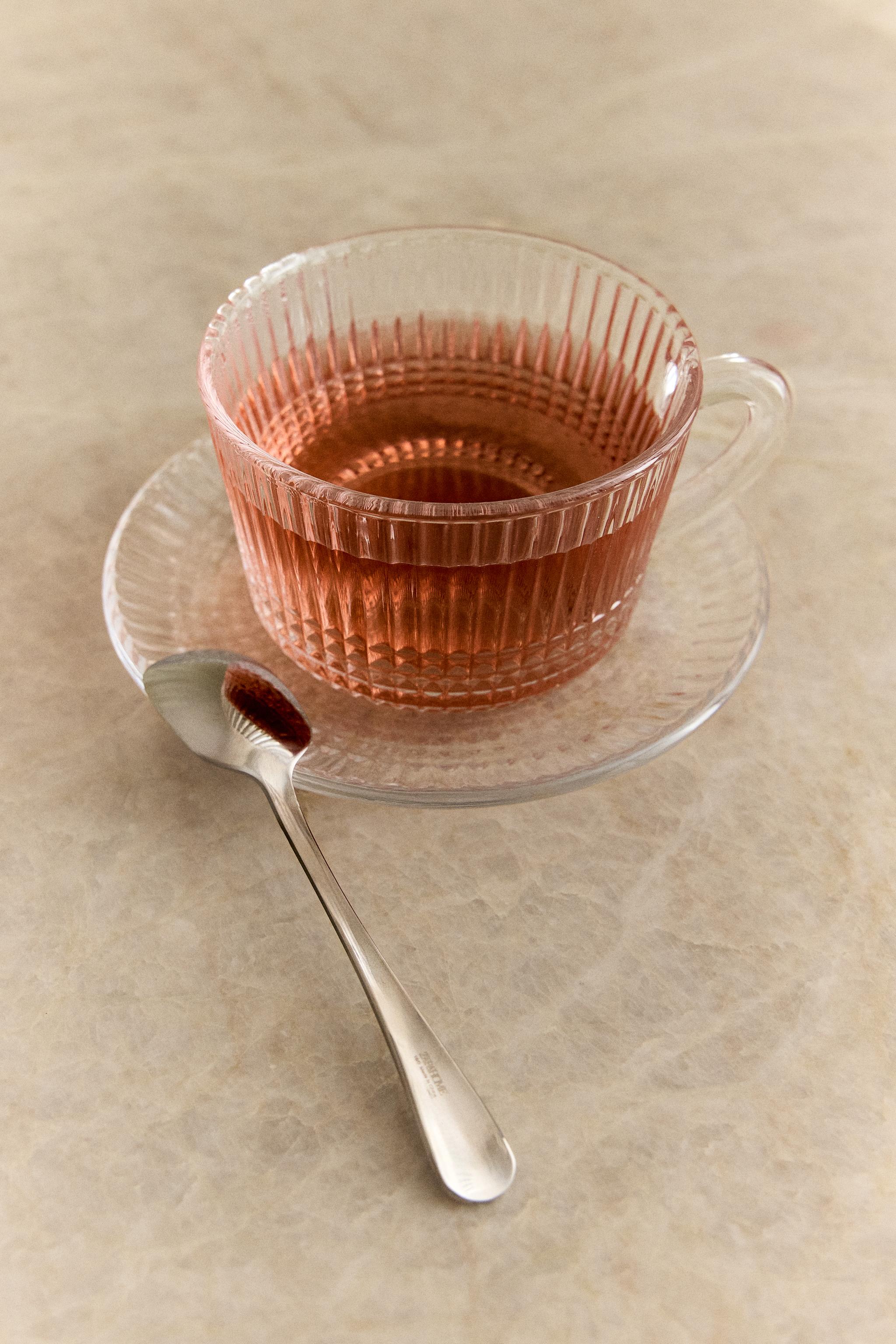 RAISED GLASS TEACUP WITH GEOMETRIC DESIGN